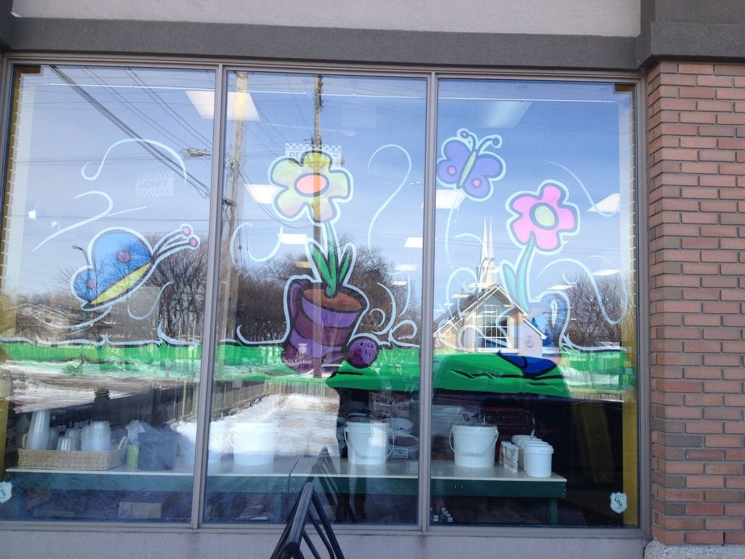 A window with flowers and butterflies painted on it