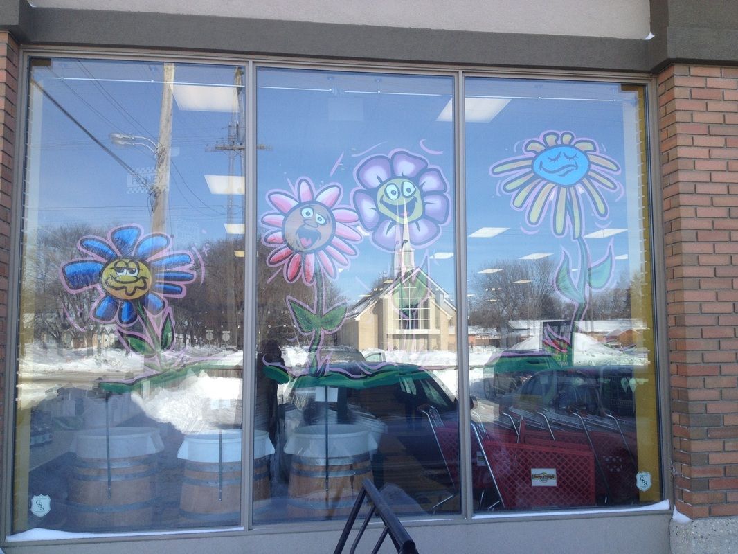 A store window with flowers painted on it