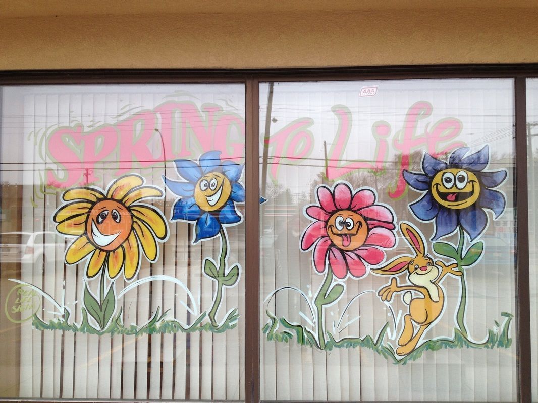 A window with flowers and a rabbit painted on it