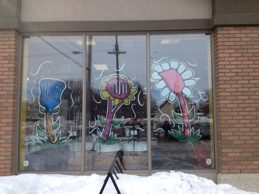 A brick building with flowers painted on the windows