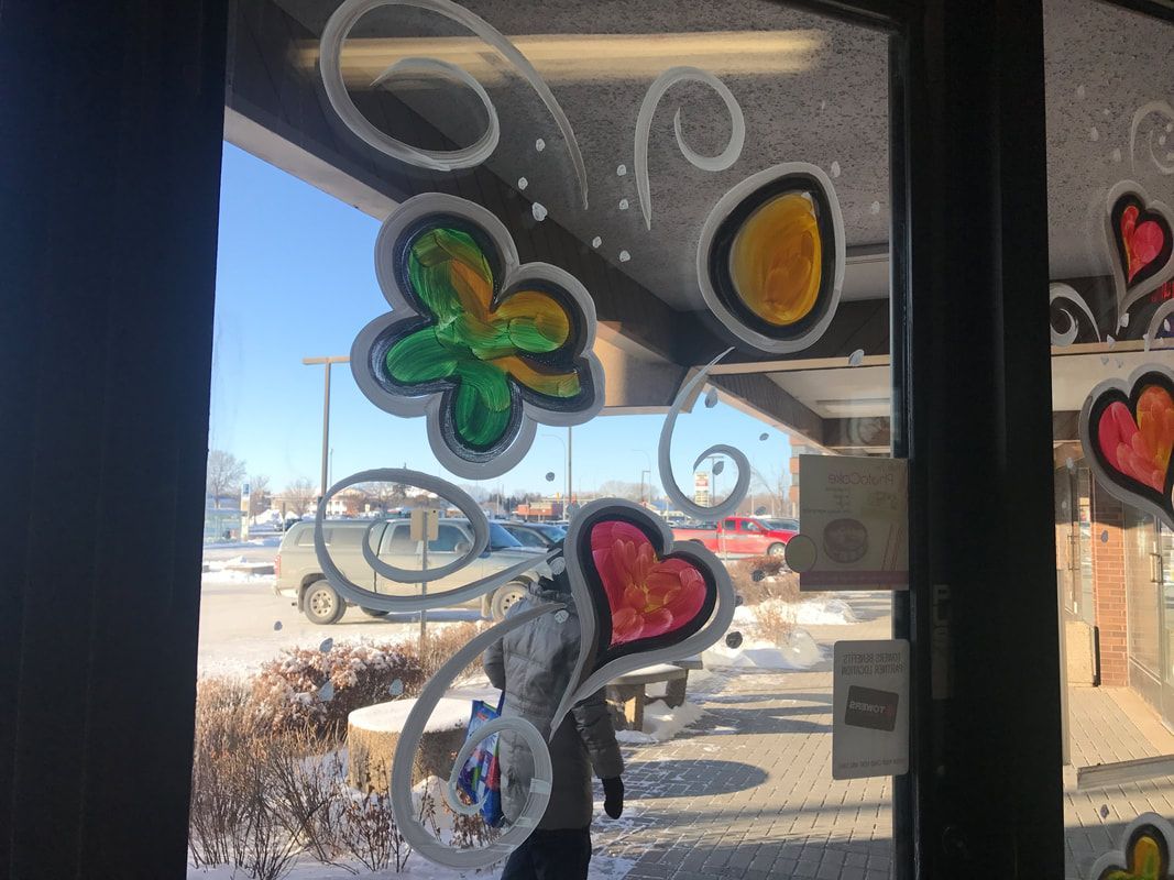 A window with flowers and hearts painted on it