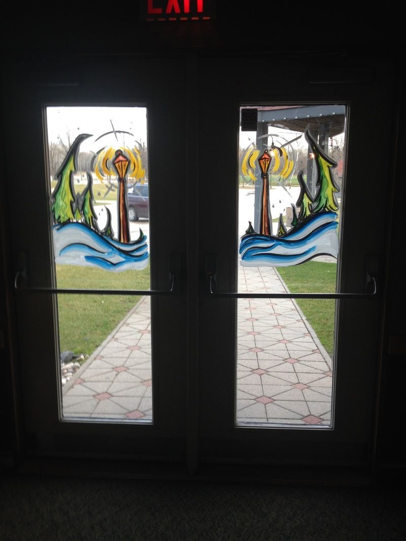 A stained glass door with a dolphin on it