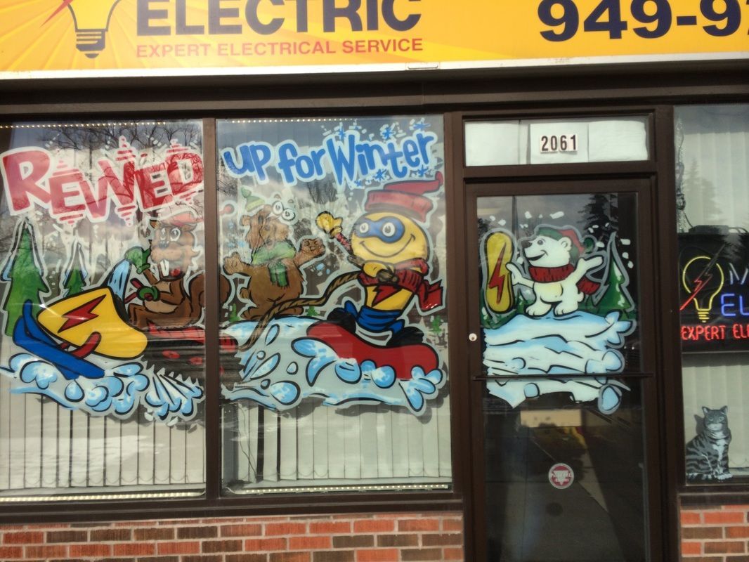 A brick building with a yellow sign that says electric