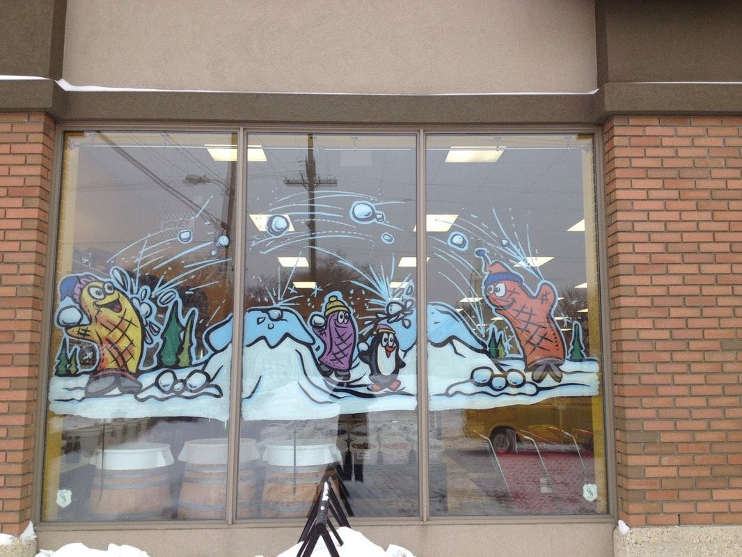 A brick building with a window with a cartoon on it