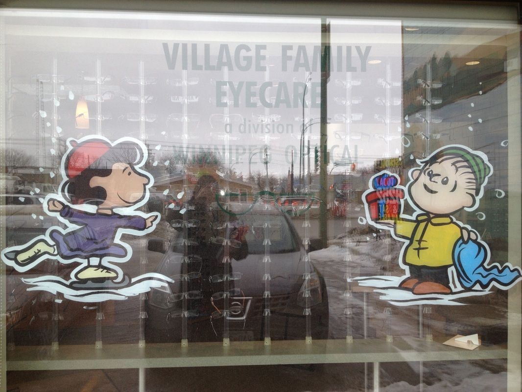 A window display for village family eyecare with peanuts characters on it