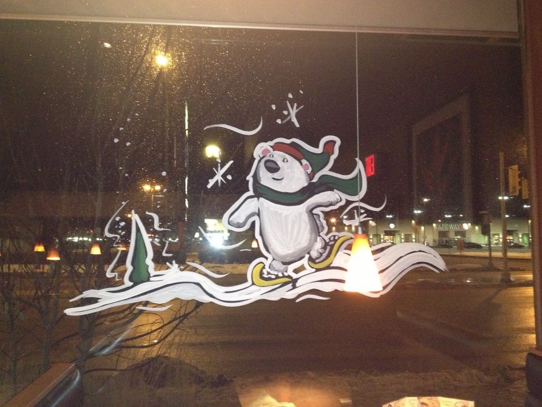 A drawing of a polar bear wearing a santa hat and scarf