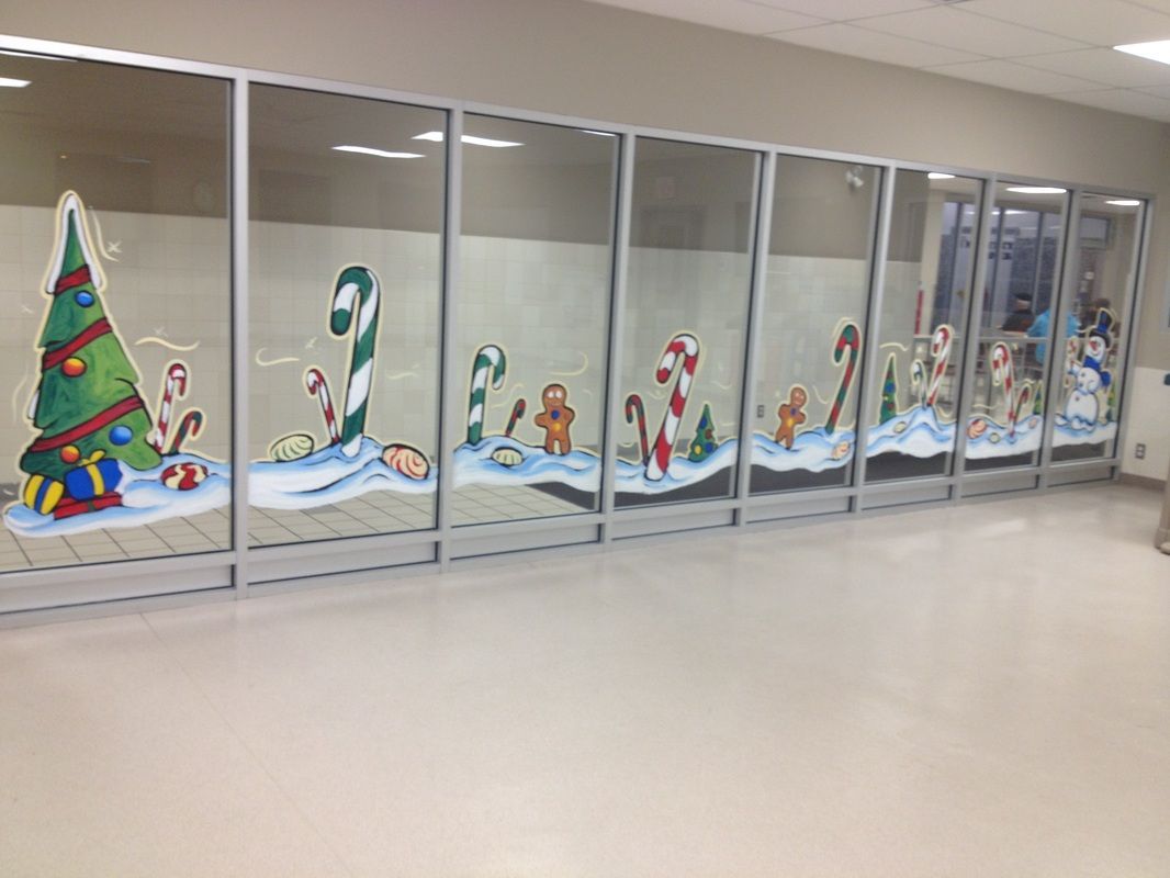 A long hallway with christmas decorations on the windows.