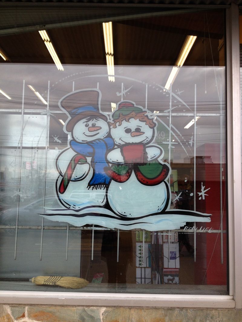 A stained glass window with two snowmen on it