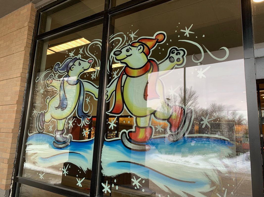 A window with a painting of two polar bears on it.