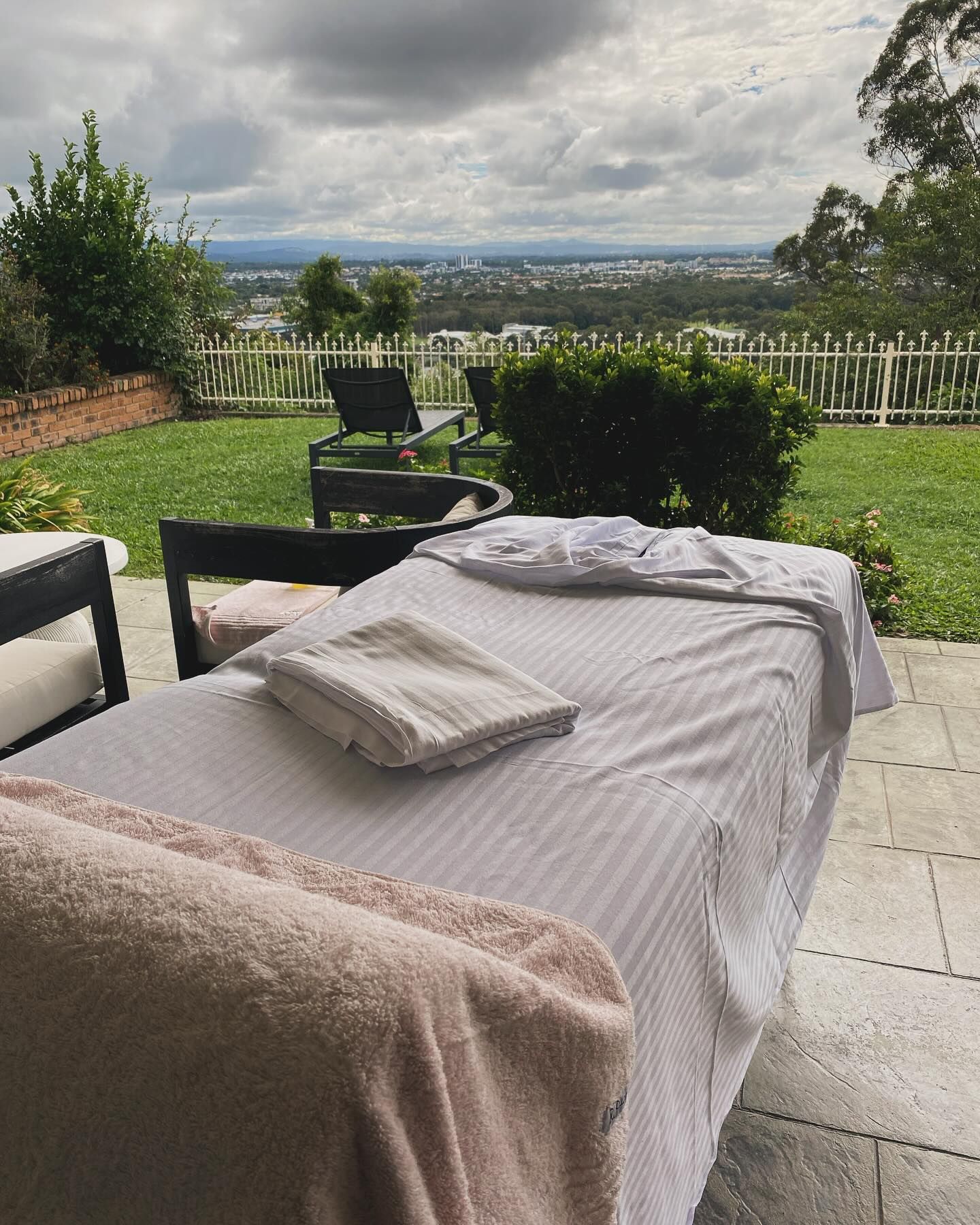 Massage Table on A Patio Overlooking a City — Soul Good Beauty in Miami, QLD