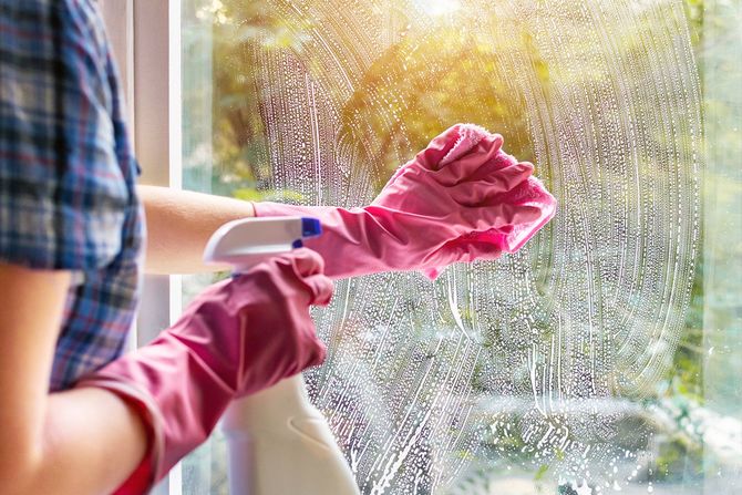 woman clean window pane rag soap