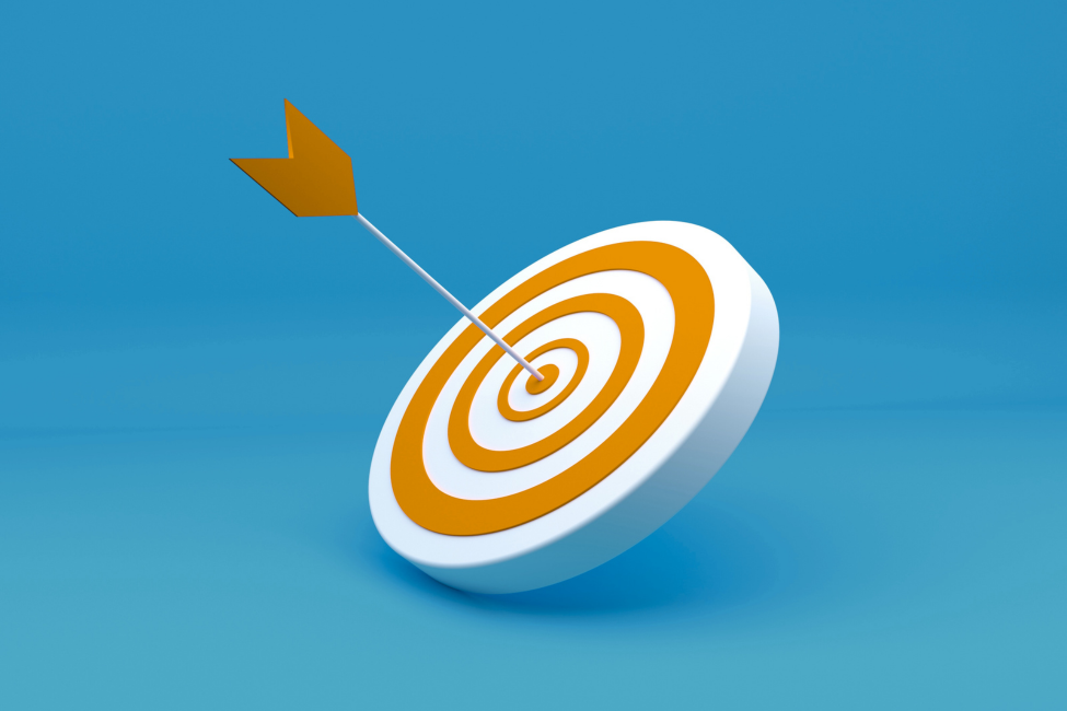 Arrow hitting the center of a white and orange target on a blue background.