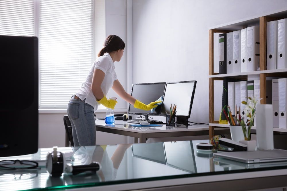 Woman is Cleaning a Computer Monitor in an Office — Active Cleaning Service Rutherford, NSW