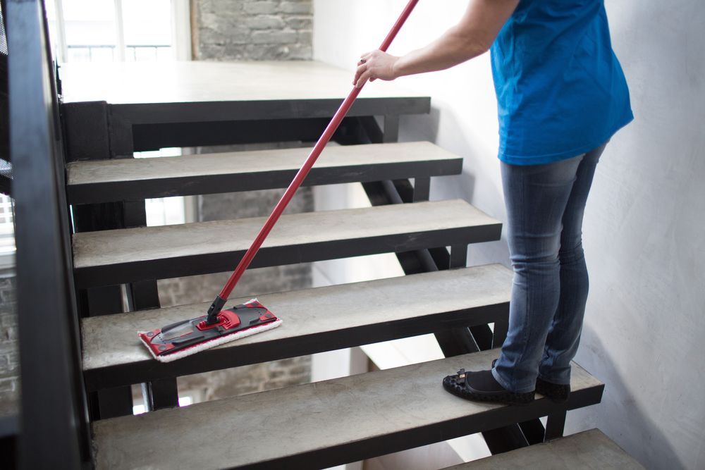 Woman is Cleaning the Stairs With a Mop — Active Cleaning Service Rutherford, NSW