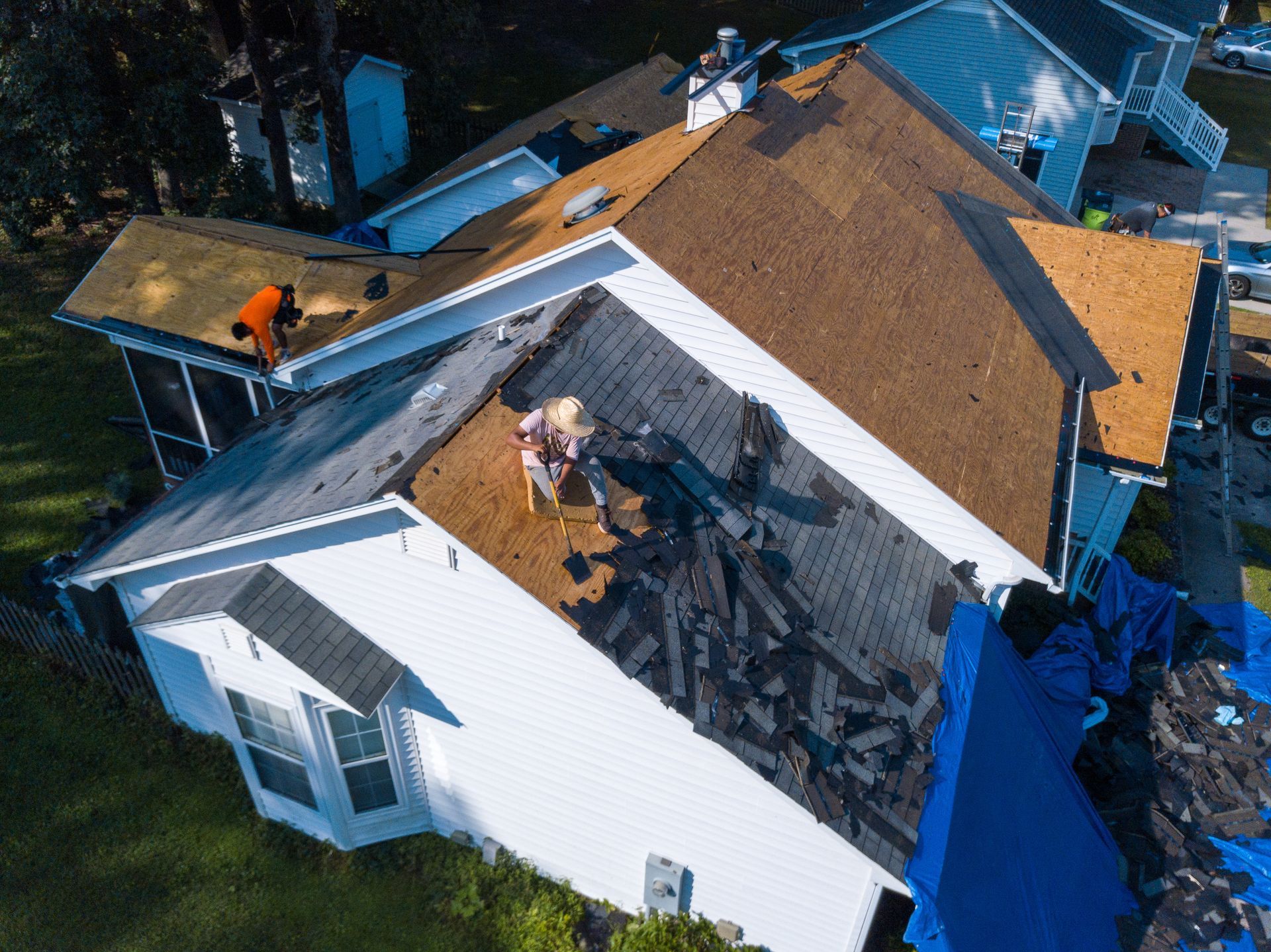 A crew of men is removing a roof.