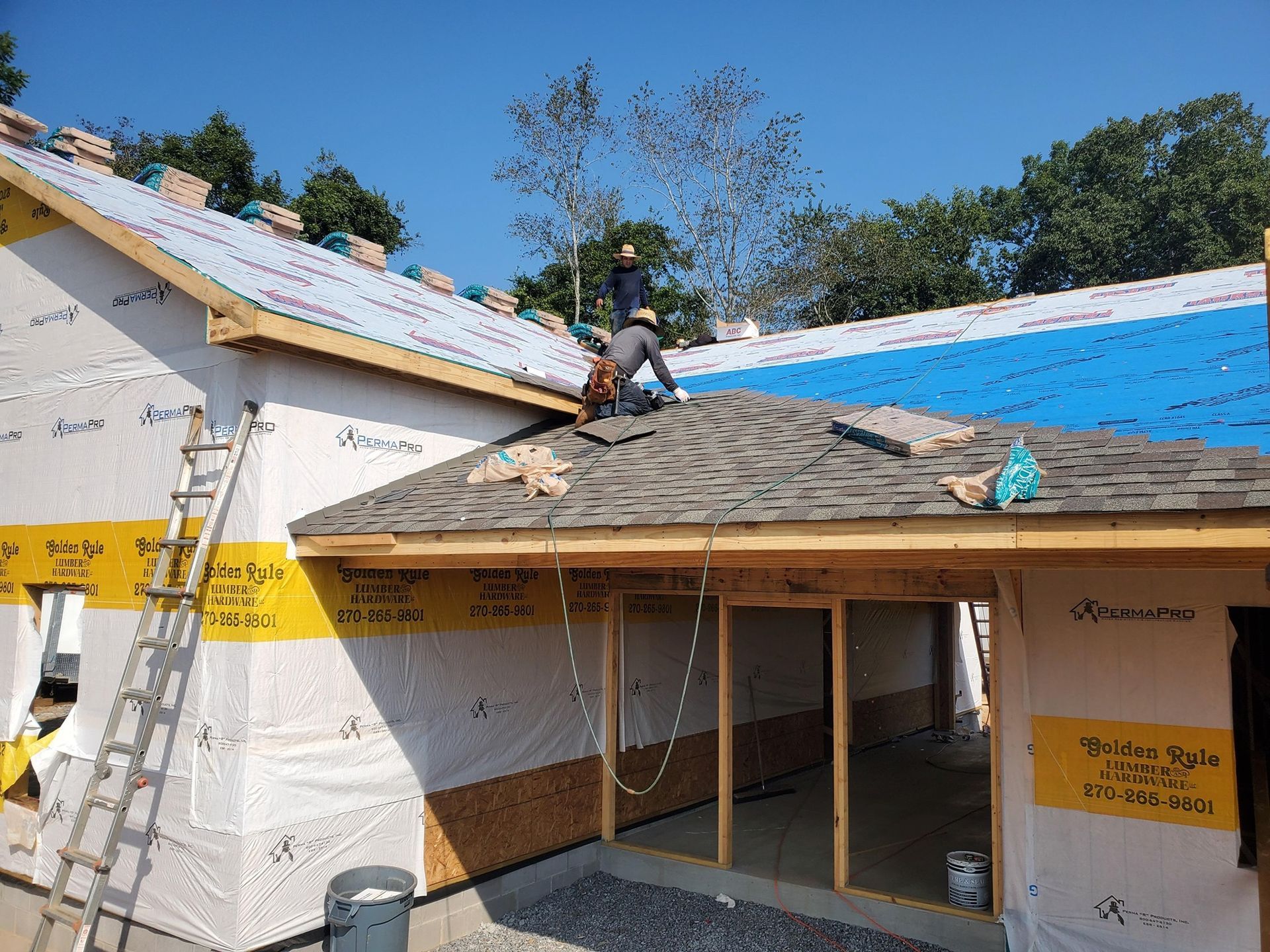 Gray asphalt roof shingles with a ridge vent along the rooftop. Gray asphalt roof shingles with a ridge vent along the rooftop.