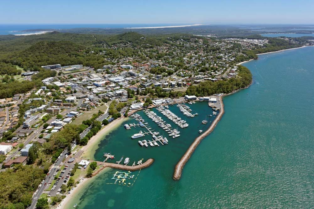 An Aerial View Of A Marina With Boats Docked In It — Air Conditioning Electricians in Port Stephens, NSW