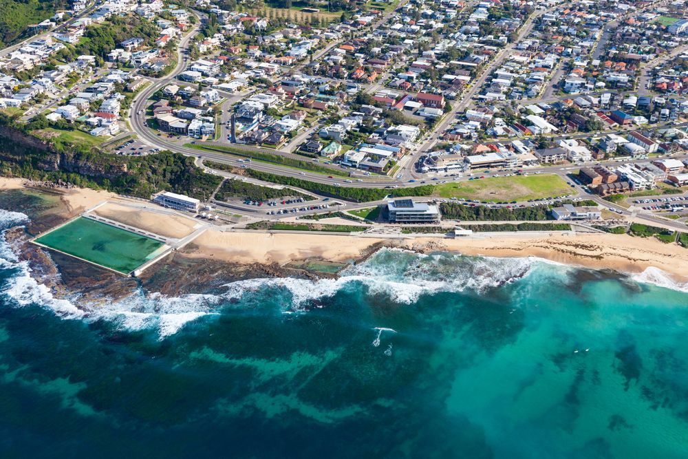 Aerial View of a Coastal Town With Turquoise Waves — Aircon Mid North Coast in Newcastle, NSW