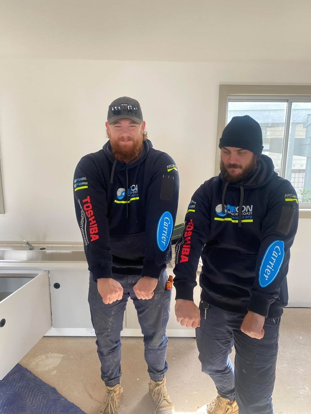 Two Men Showing Off Their Fist — Aircon Mid North Coast in Forster, NSW