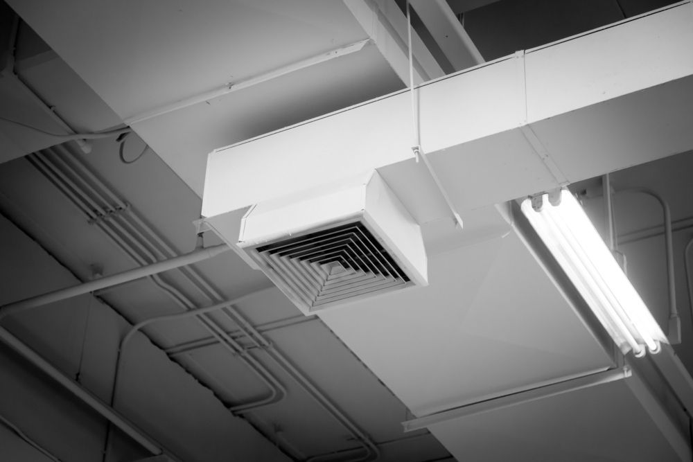 A Black And White Photo Of An Air Duct In A Building — Aircon Mid North Coast in Harrington, NSW