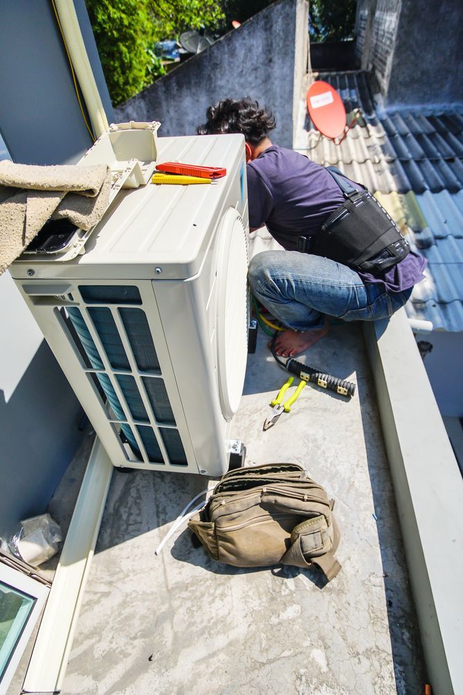 HVAC Technician Installing an Air Conditioning Unit on a Rooftop