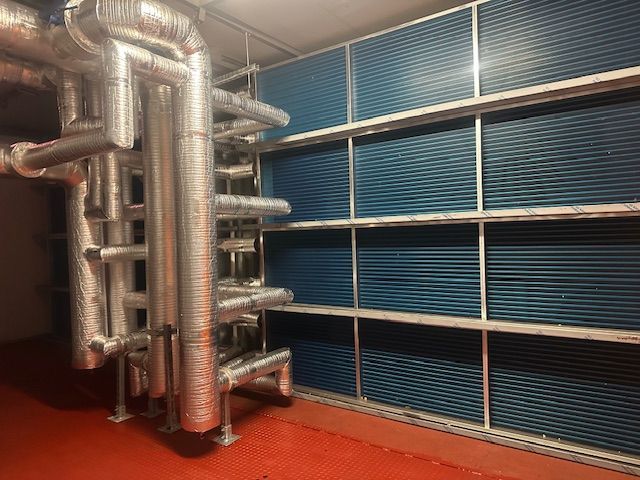 Two Air Conditioners Are Sitting Next To Each Other Outside Of A Building — Aircon Mid North Coast in Forster, NSW