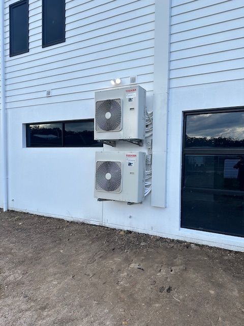 There Are A Lot Of Fans On The Roof Of A Building — Aircon Mid North Coast in Taree, NSW
