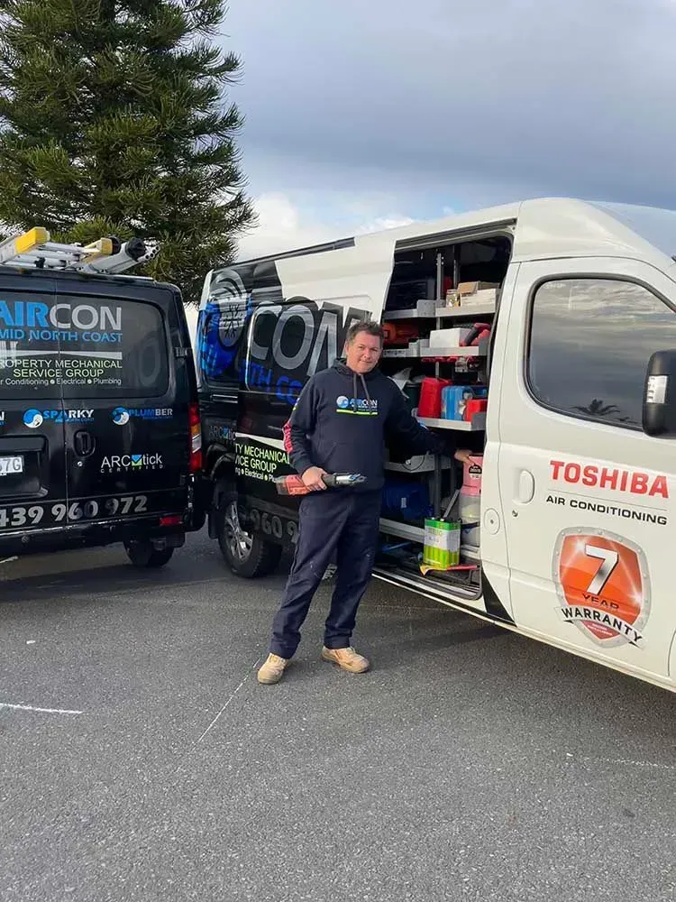 Man Standing Next To A White Van With Open Side, Tools Visible