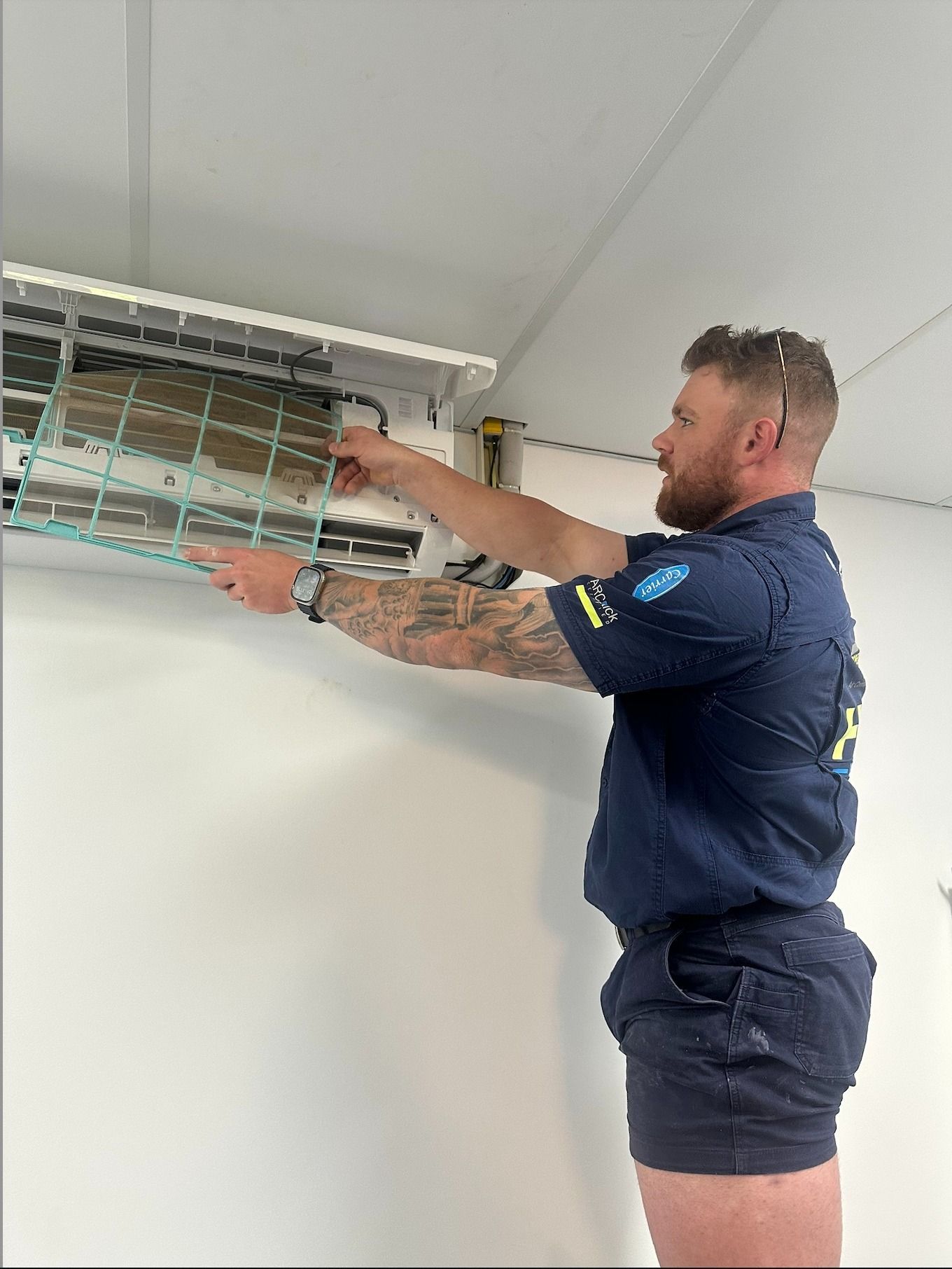 Worker Replacing Air Conditioner Filter