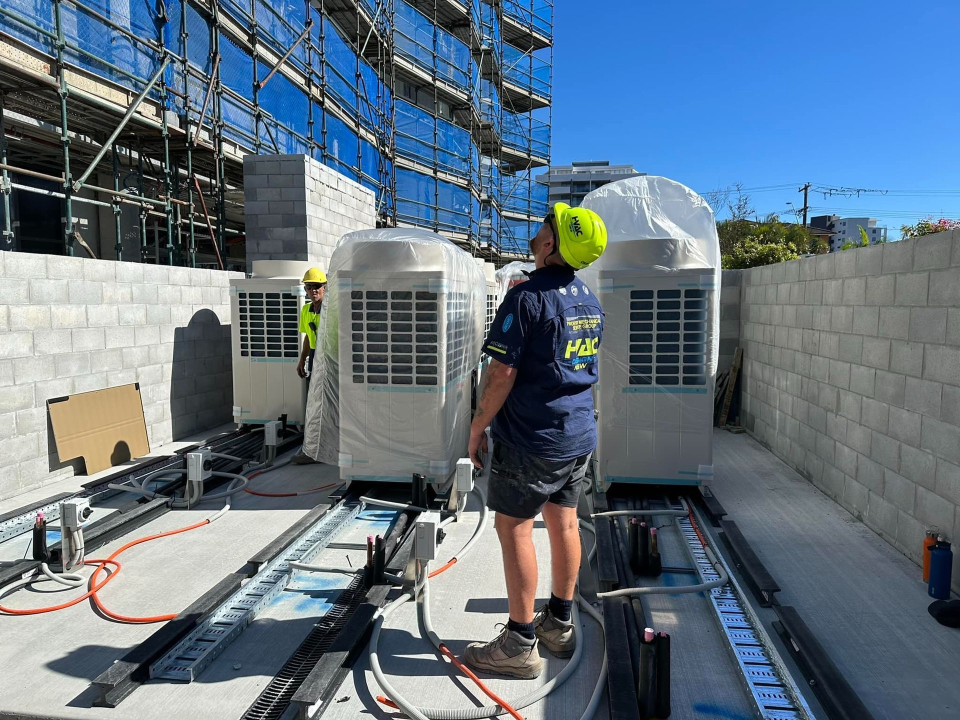 Workers Installing Large HVAC Units