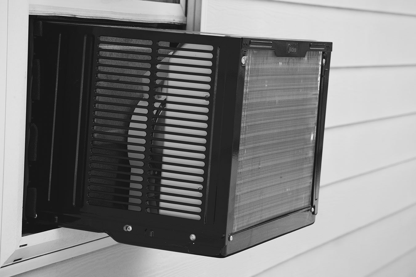 A Black And White Photo Of A Window Air Conditioner — Aircon Mid North Coast in Forster, NSW