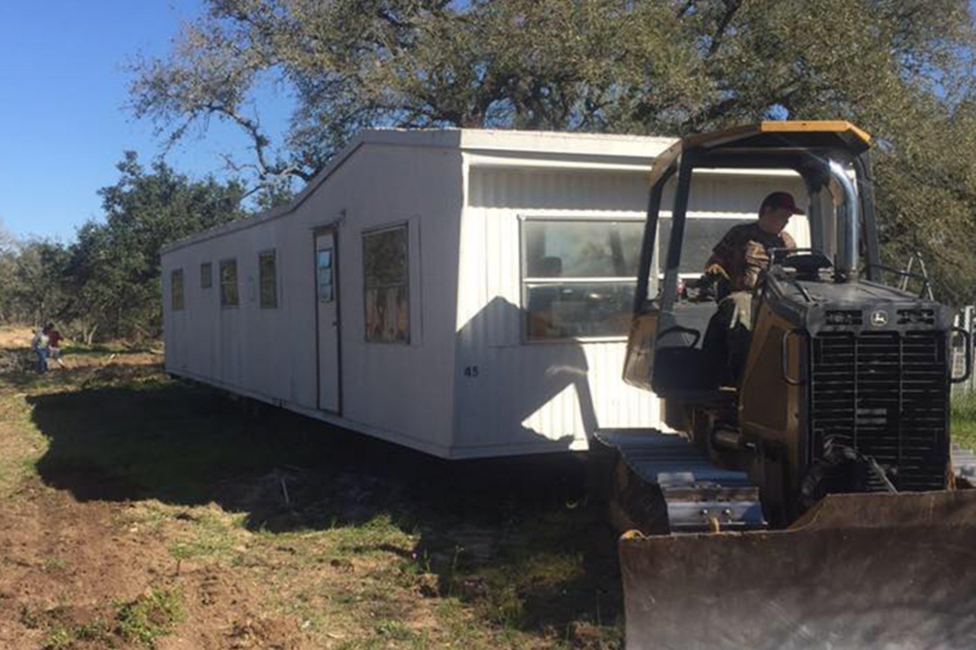 Bulldozer Truck Pulling Prefabricated Container Home — San Antonio, TX — Martinez Mobile Home Transporting