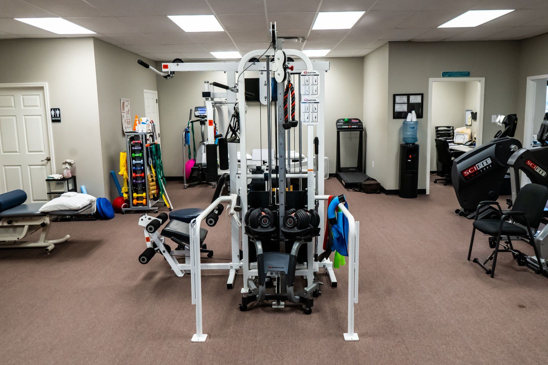 a gym filled with lots of exercise equipment and a treadmill .