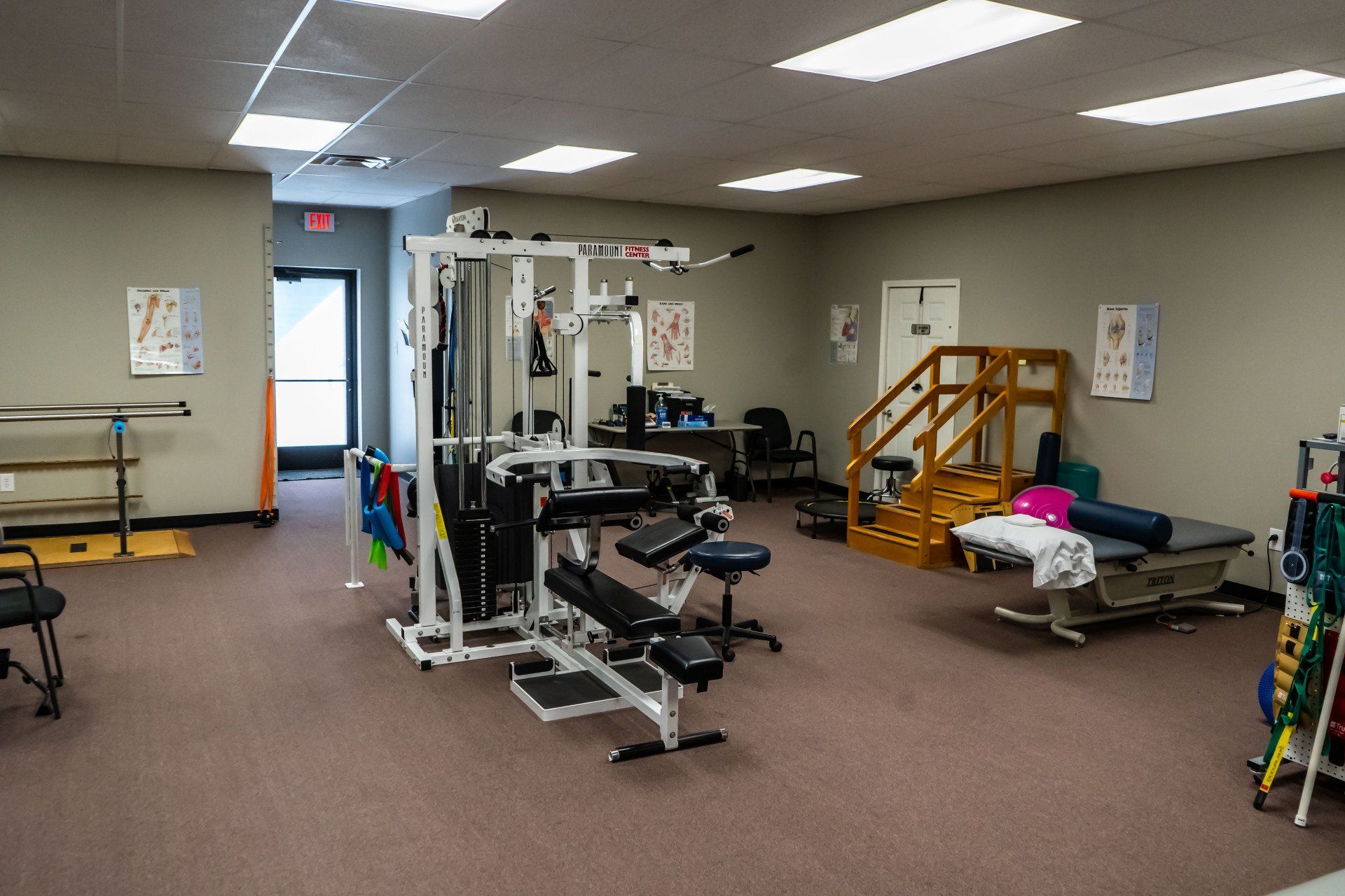 a large room with a lot of exercise equipment in it .