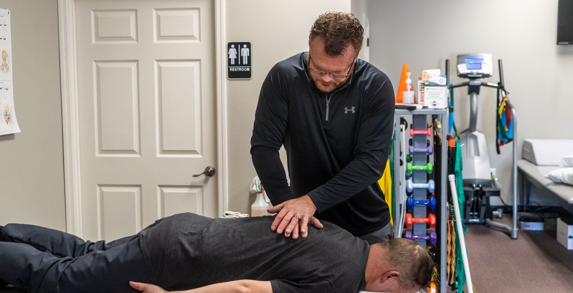 a physical therapist is working on a patient's back