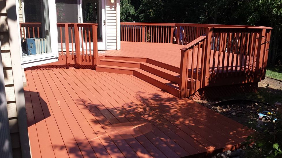 A large red deck with stairs leading up to it