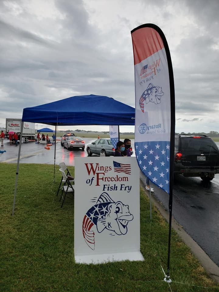 A sign that says wings of freedom fish fry on it