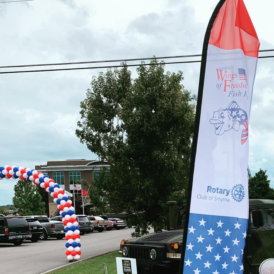 A red white and blue banner that says wings of freedom fish