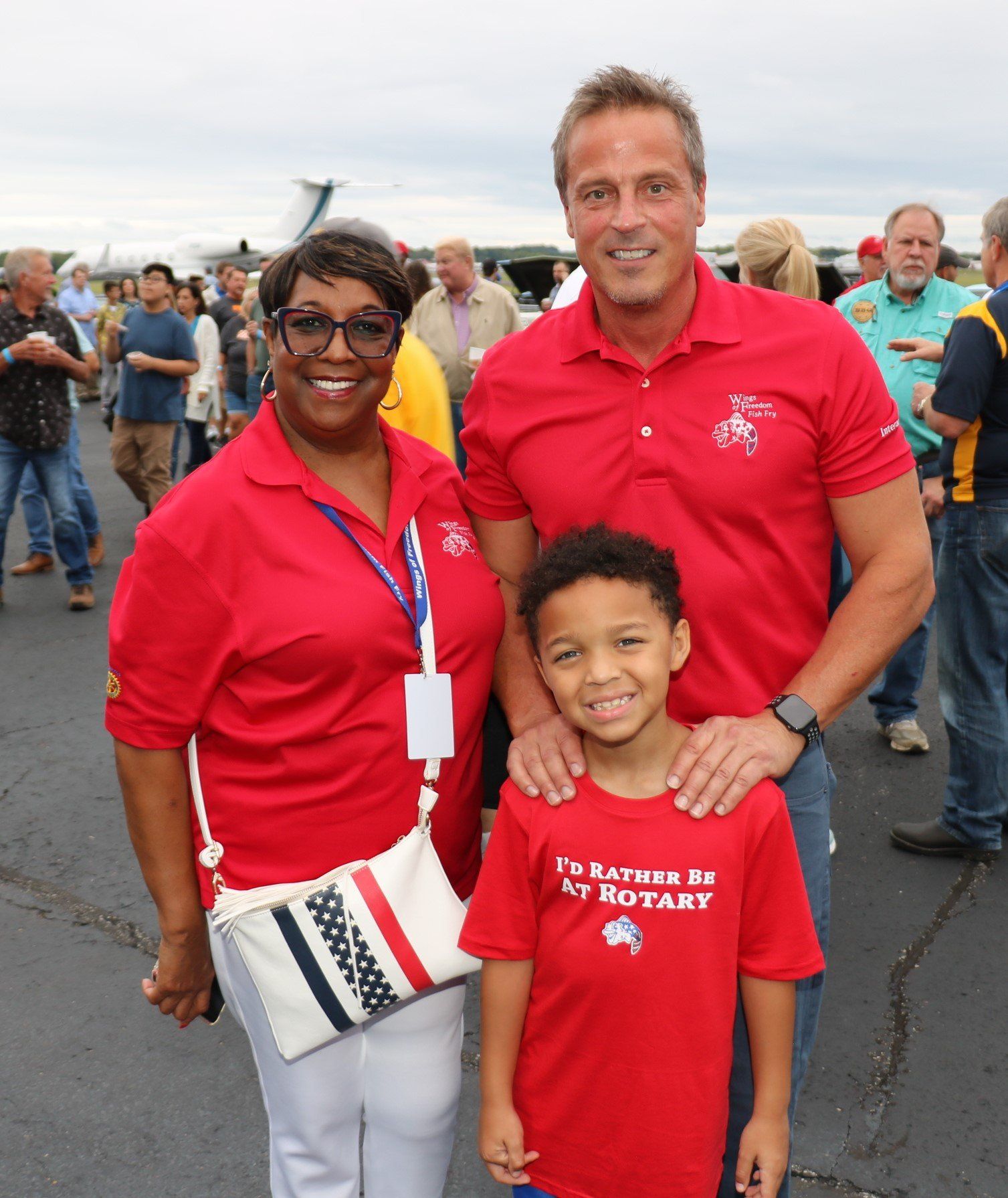 A boy wearing a red shirt that says i 'm rotary