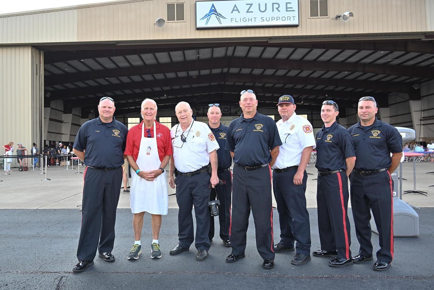 A group of men standing in front of a building that says azure