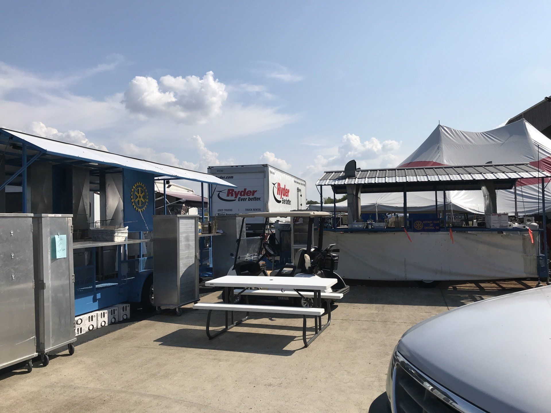 A lot of food trucks are parked in a parking lot