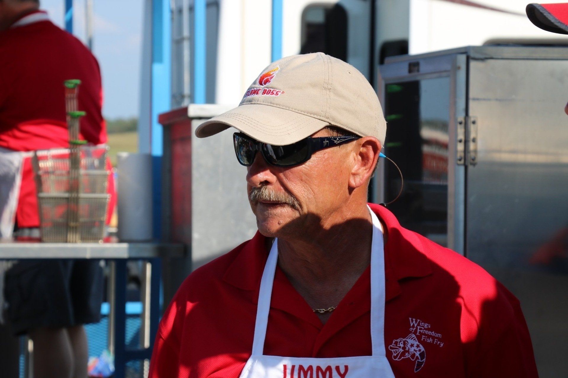 A man wearing an apron that says jimmy on it