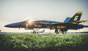 A us navy fighter jet is sitting on a runway.