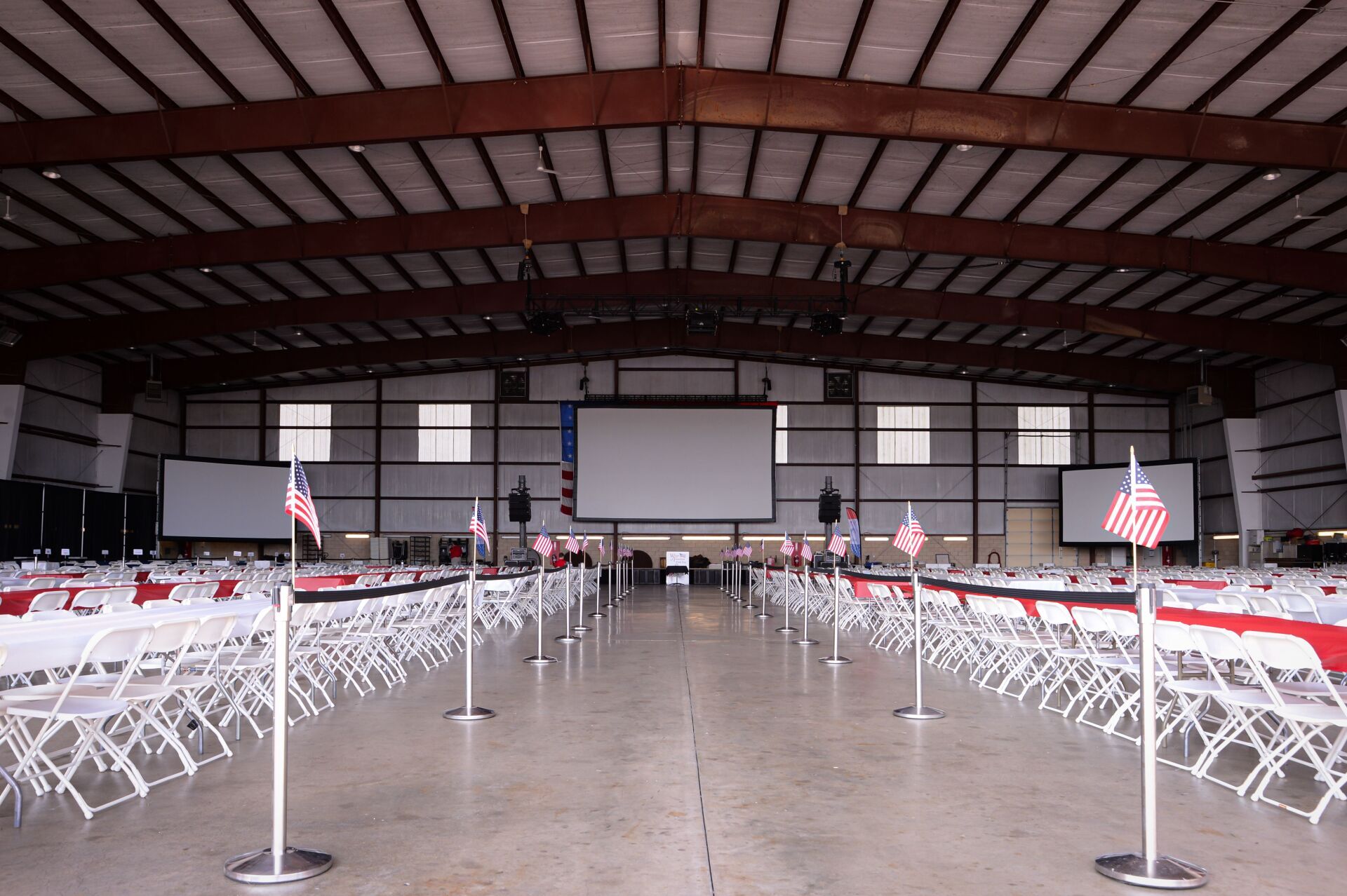 A large room with a lot of folding chairs and tables