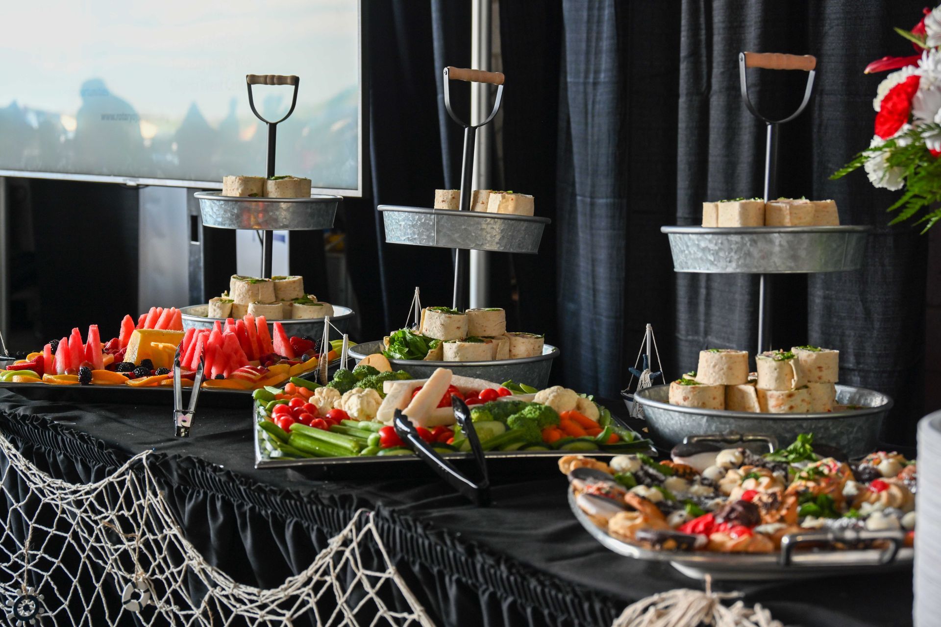 A buffet table with a variety of food on it.