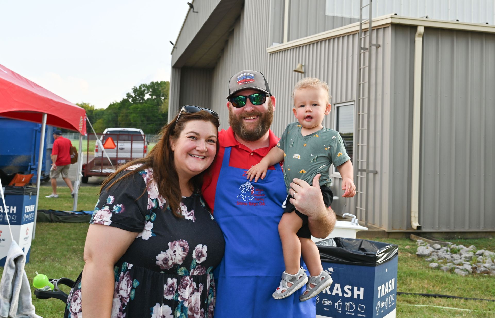 A man and a woman are posing for a picture with a baby.
