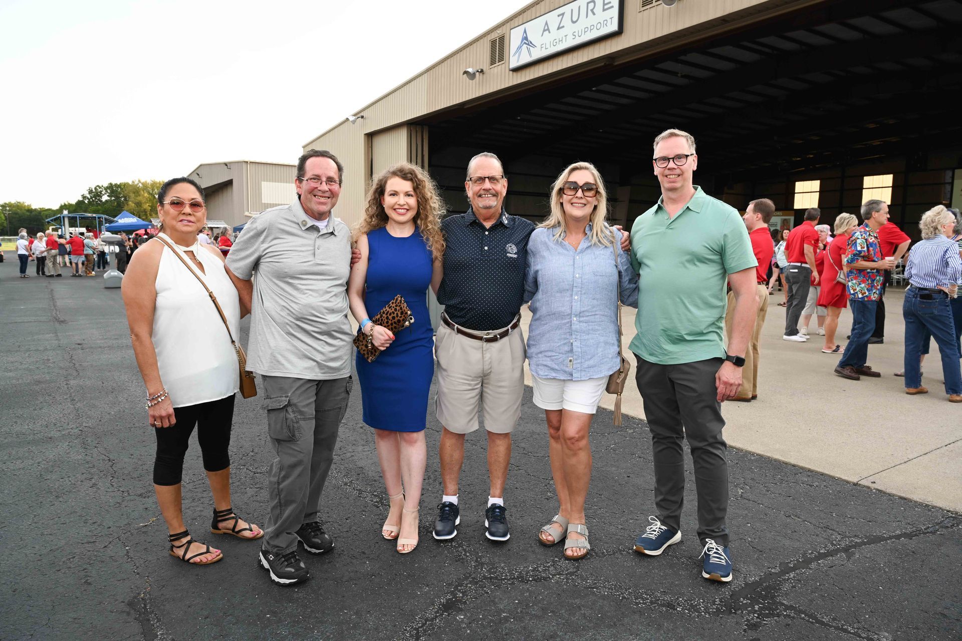 A group of people are posing for a picture in front of a building.