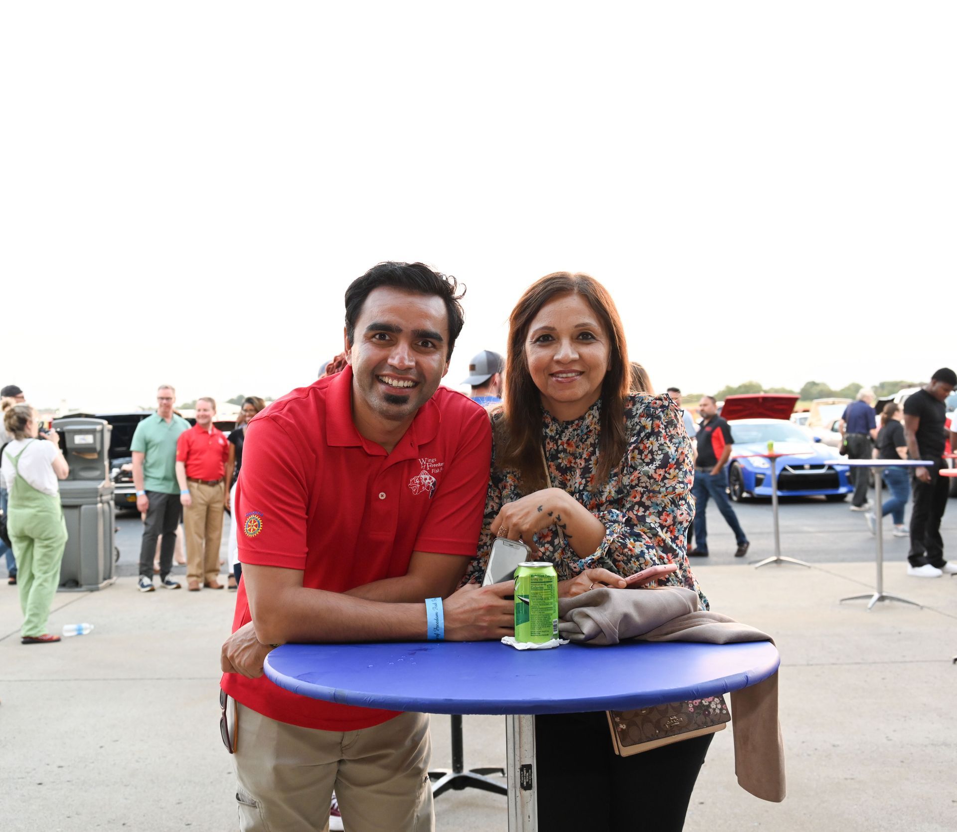 A man and a woman are sitting at a blue table