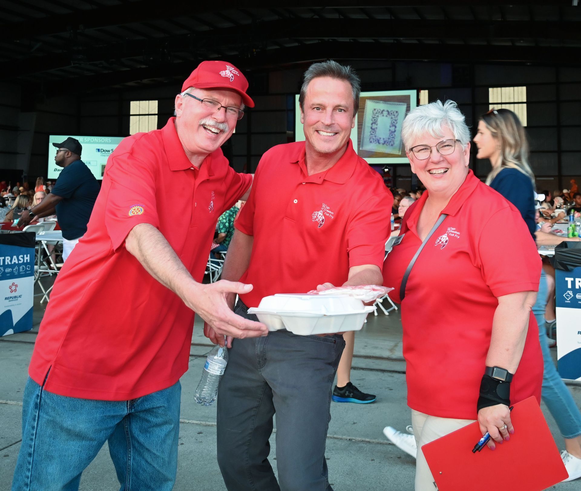 A group of people wearing red shirts are posing for a picture