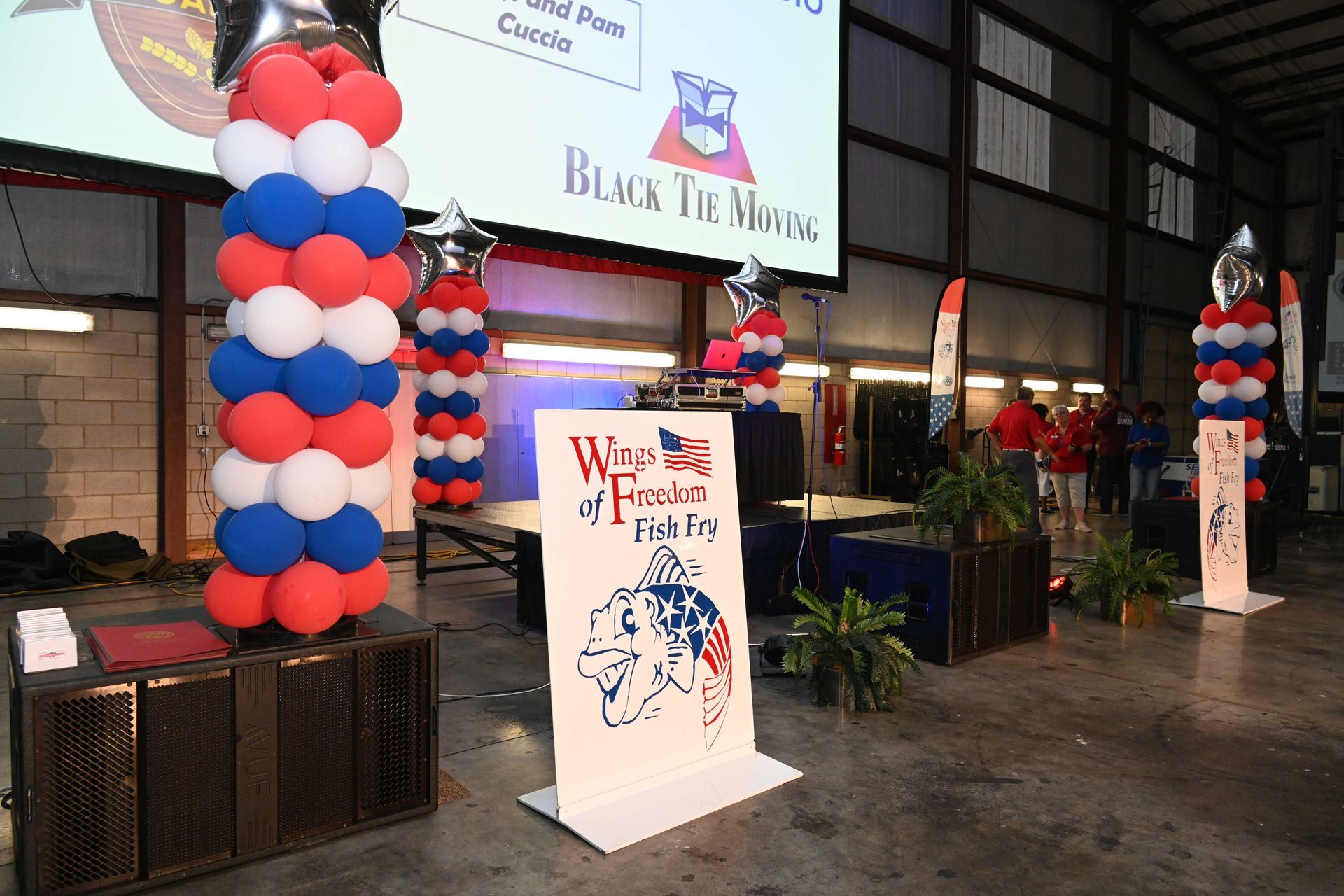 A large room with balloons and a sign that says wires of freedom